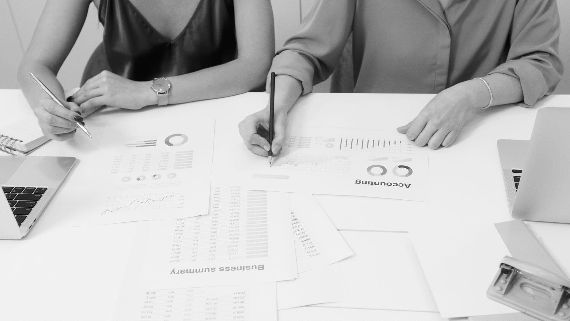 Accounting team members reviewing financial documents together in a bright modern office