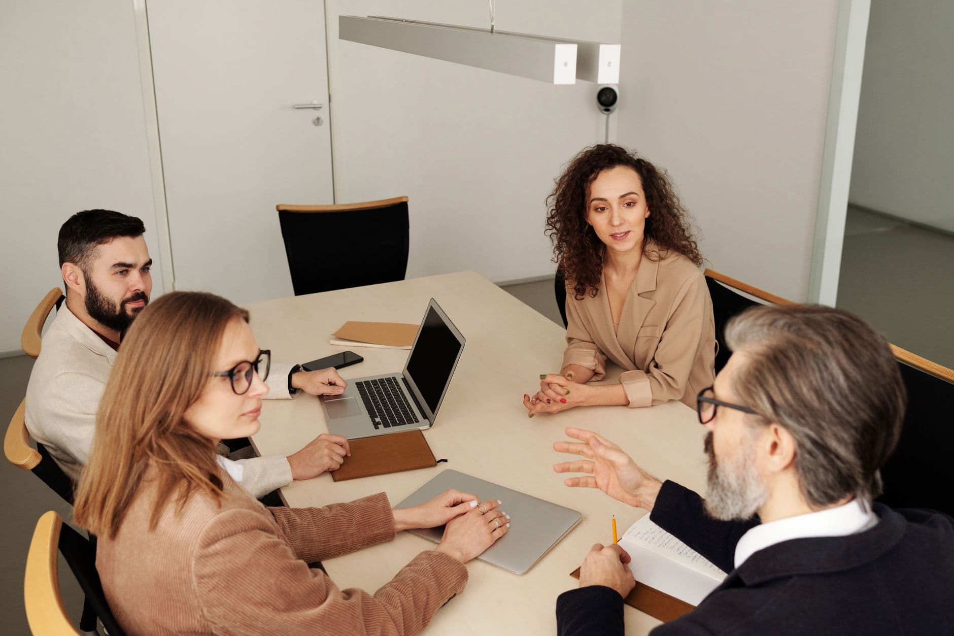 Advisor discussing financial strategy with law firm partners at a table