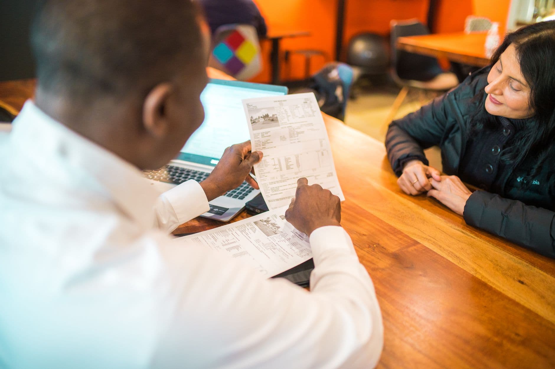 CPA advisor and business owner reviewing financial reports together at a desk