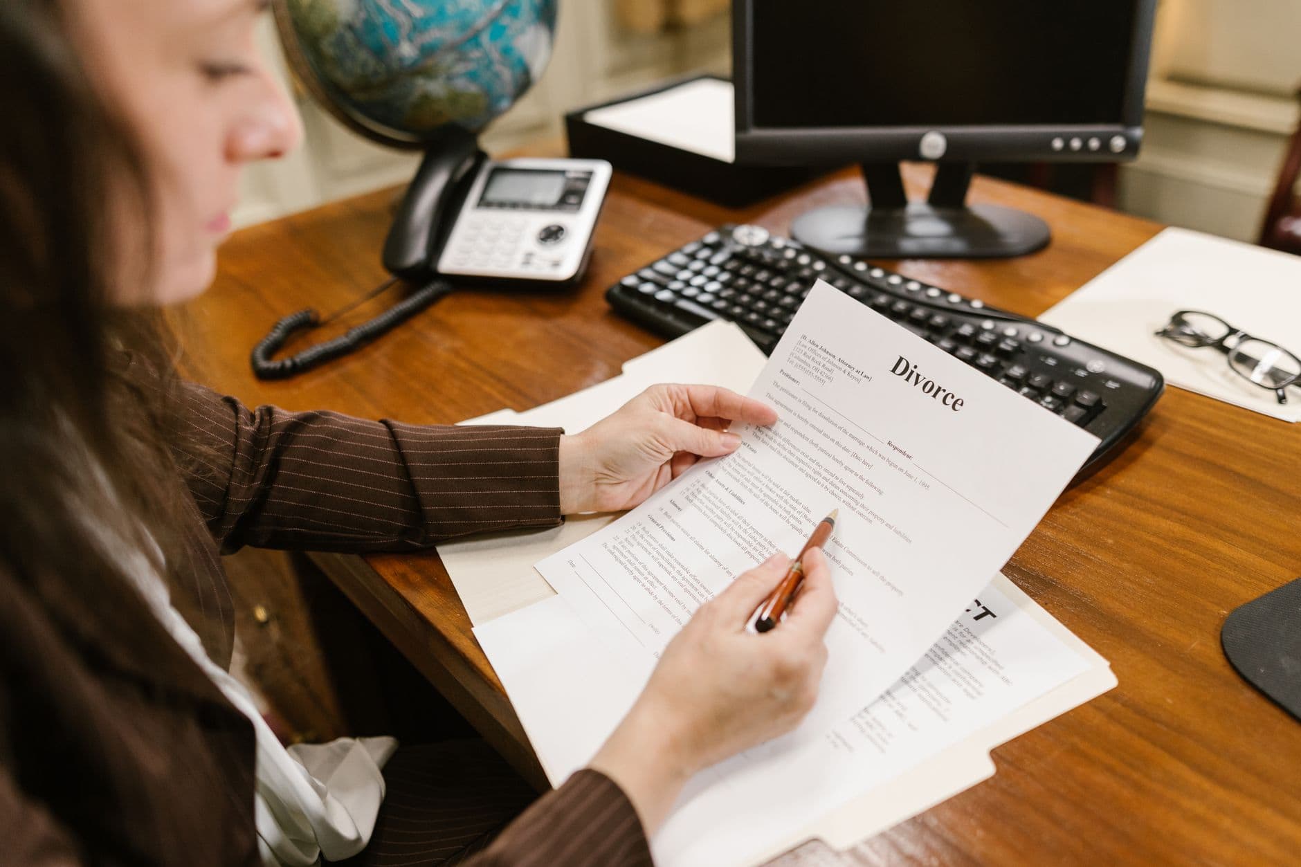 Attorney reviewing financial statements at a law office desk