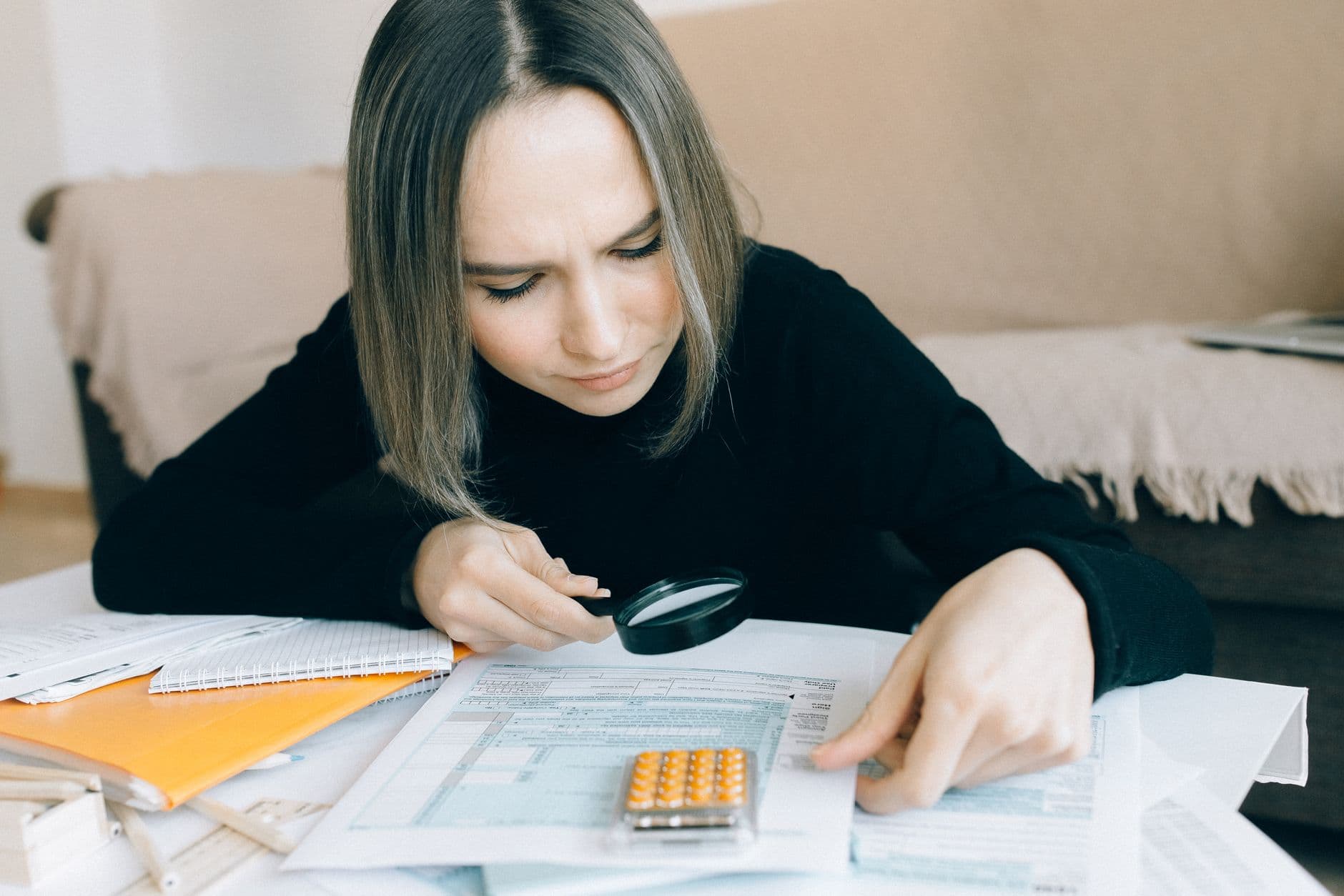 Accountant reviewing business tax documents with a client at a desk
