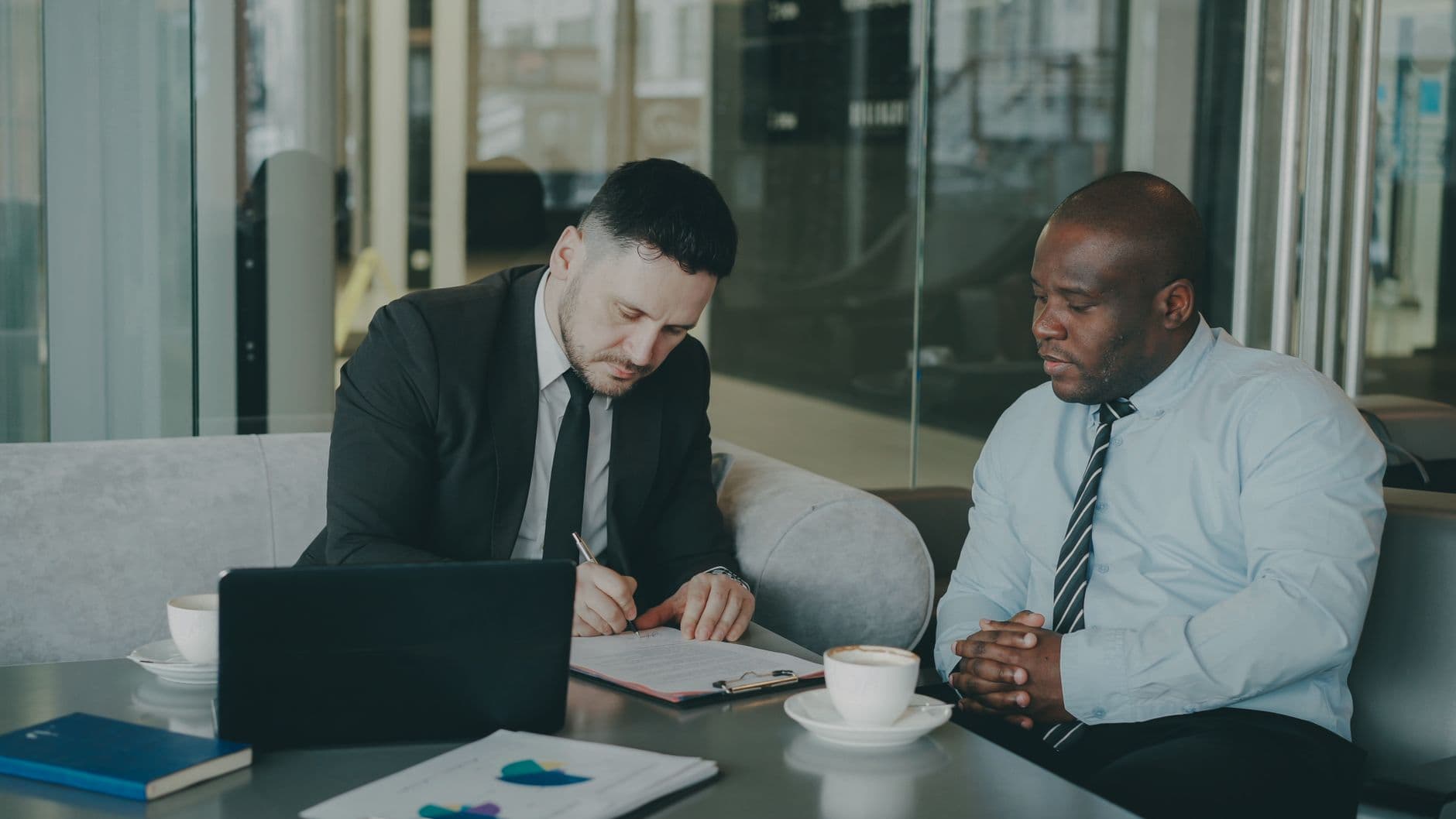 Business owner and accountant reviewing financial reports at a table