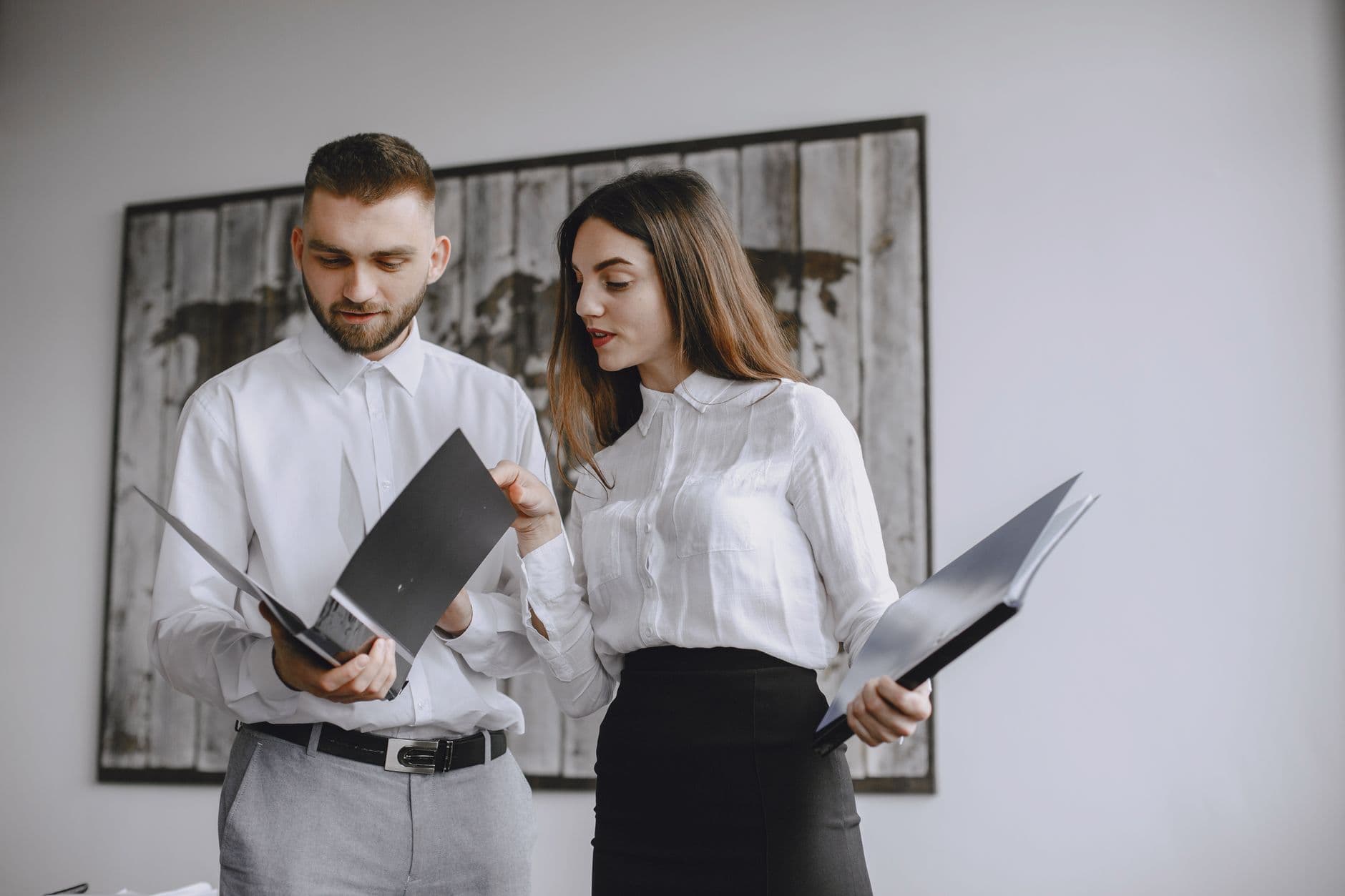 CPA reviewing personal tax documents with a client at a desk