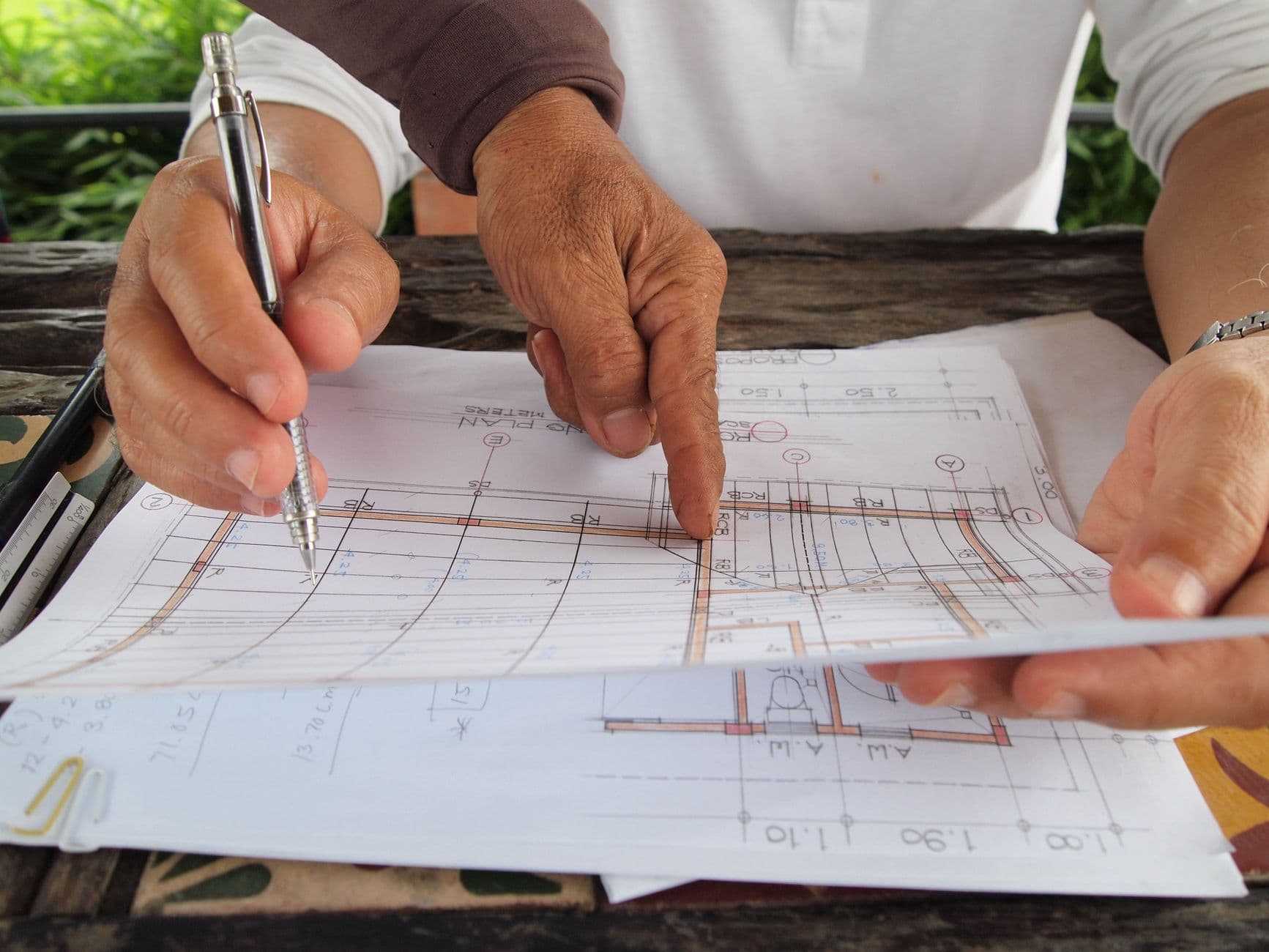 Contractor and farm owner reviewing financial paperwork with an accountant