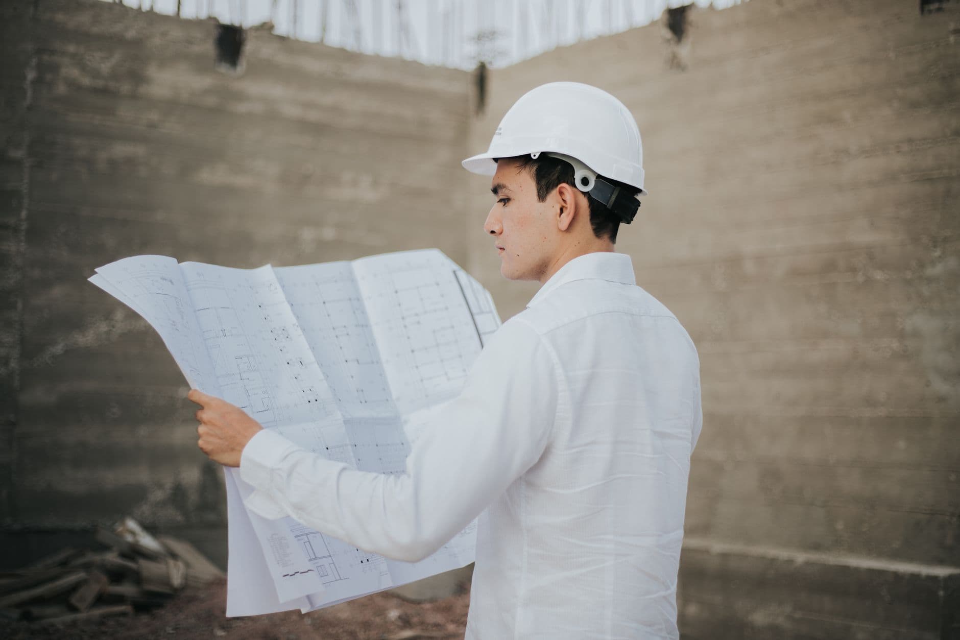 Contractor reviewing job cost reports on a construction site