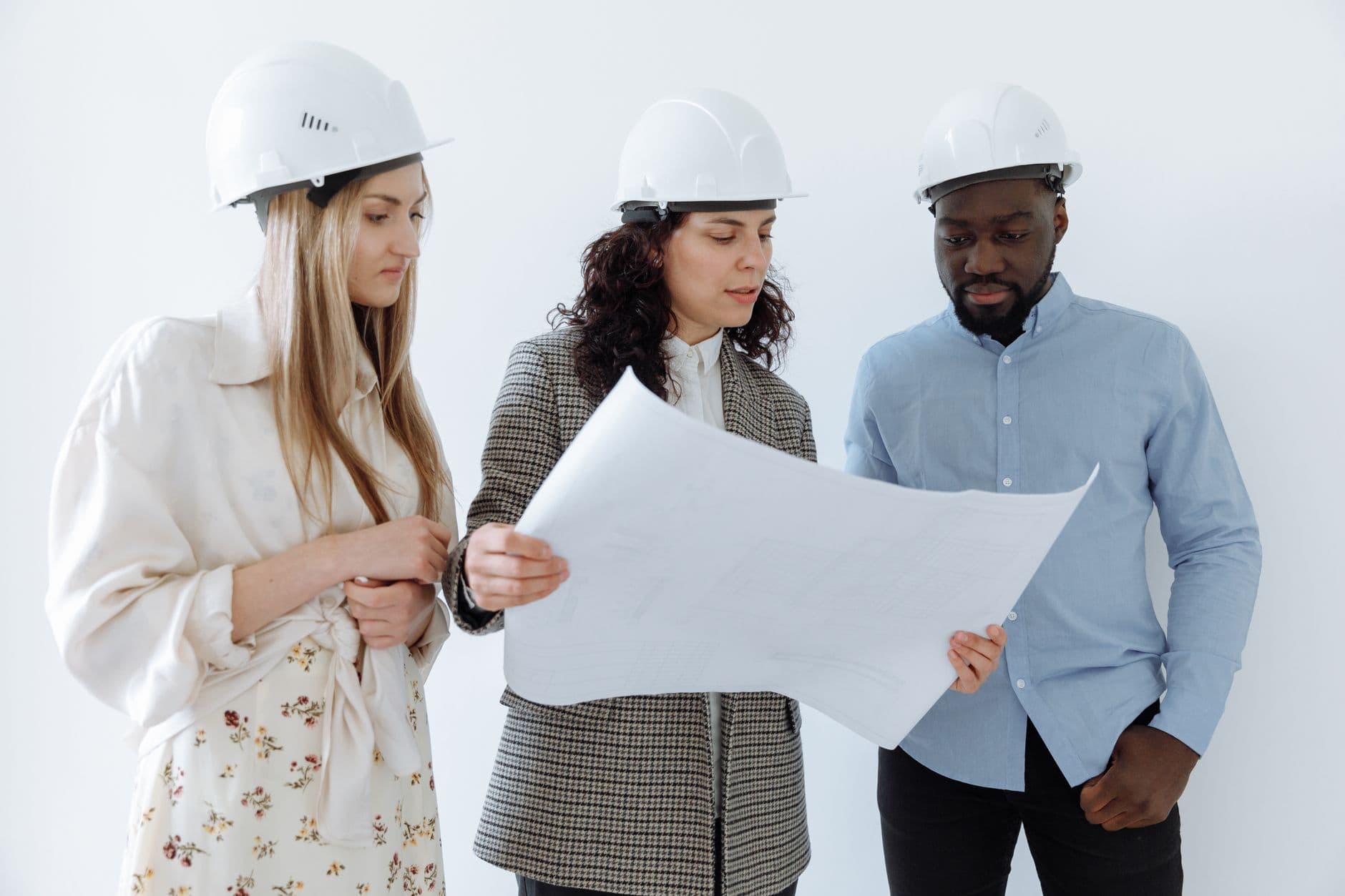 Contractor and accountant reviewing blueprints and financial reports together