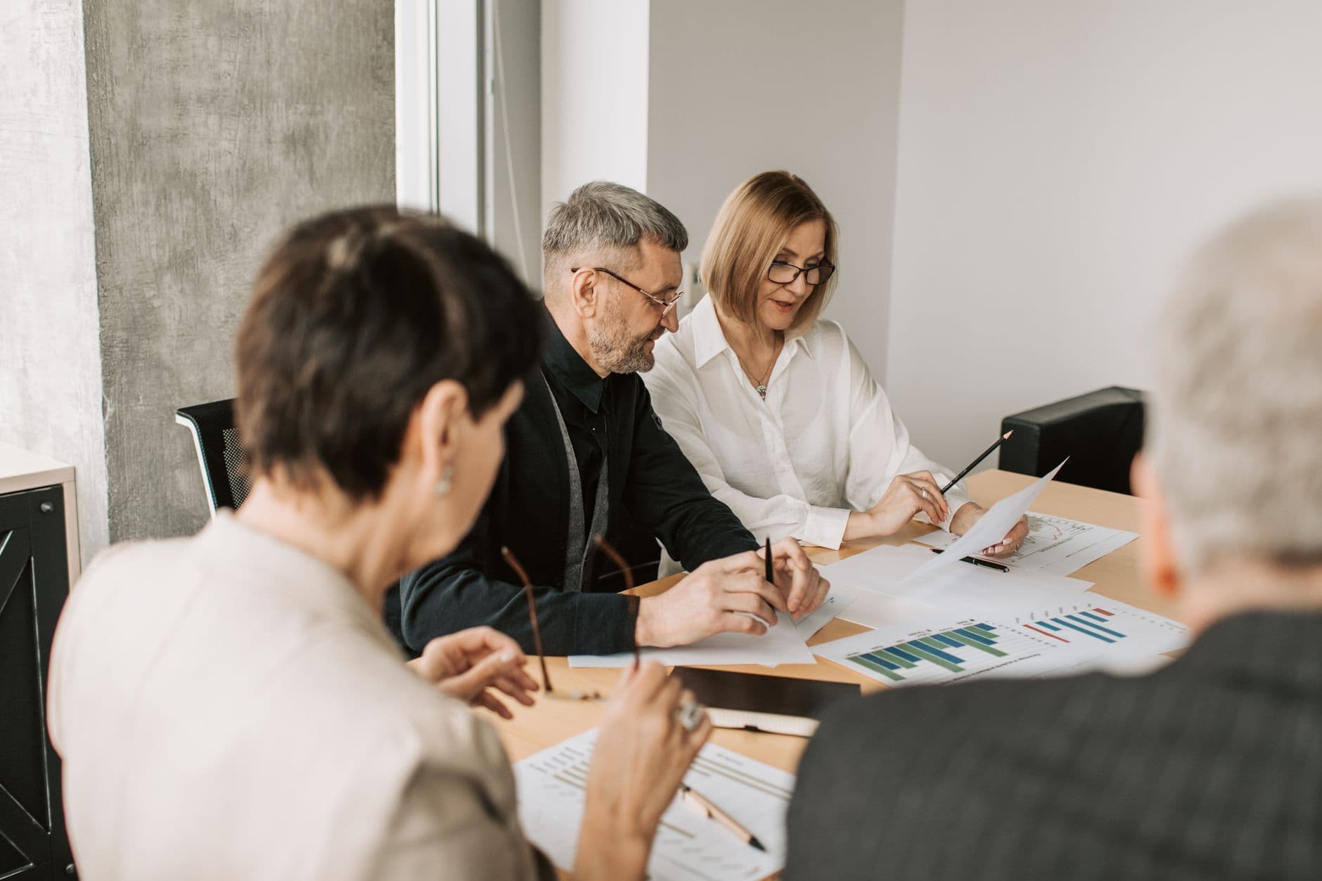 Multi-generational family meeting with financial advisor around a table