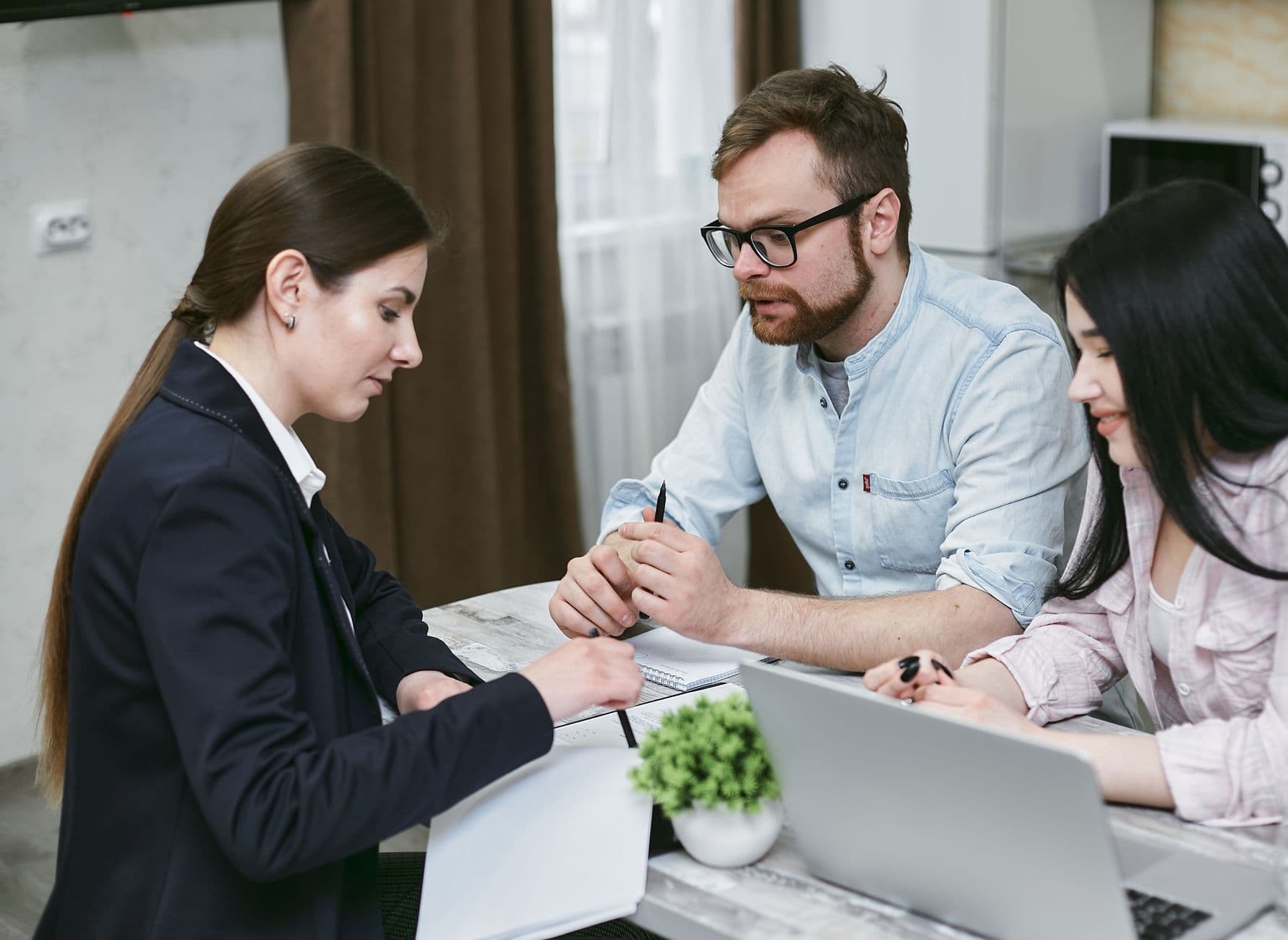 Advisor and family reviewing trust and estate financial documents together