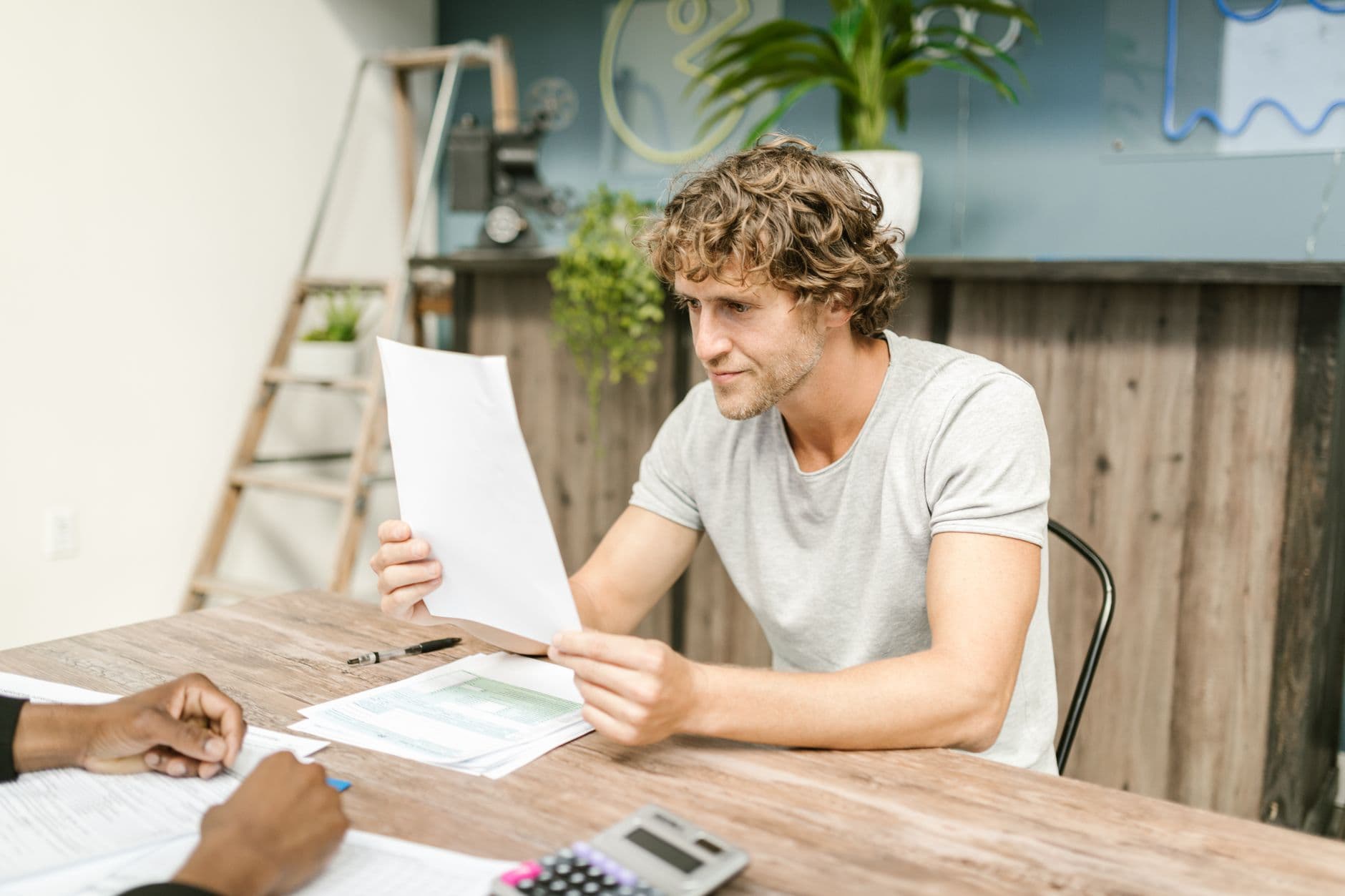 Farmer reviewing paperwork and financial documents at a kitchen table