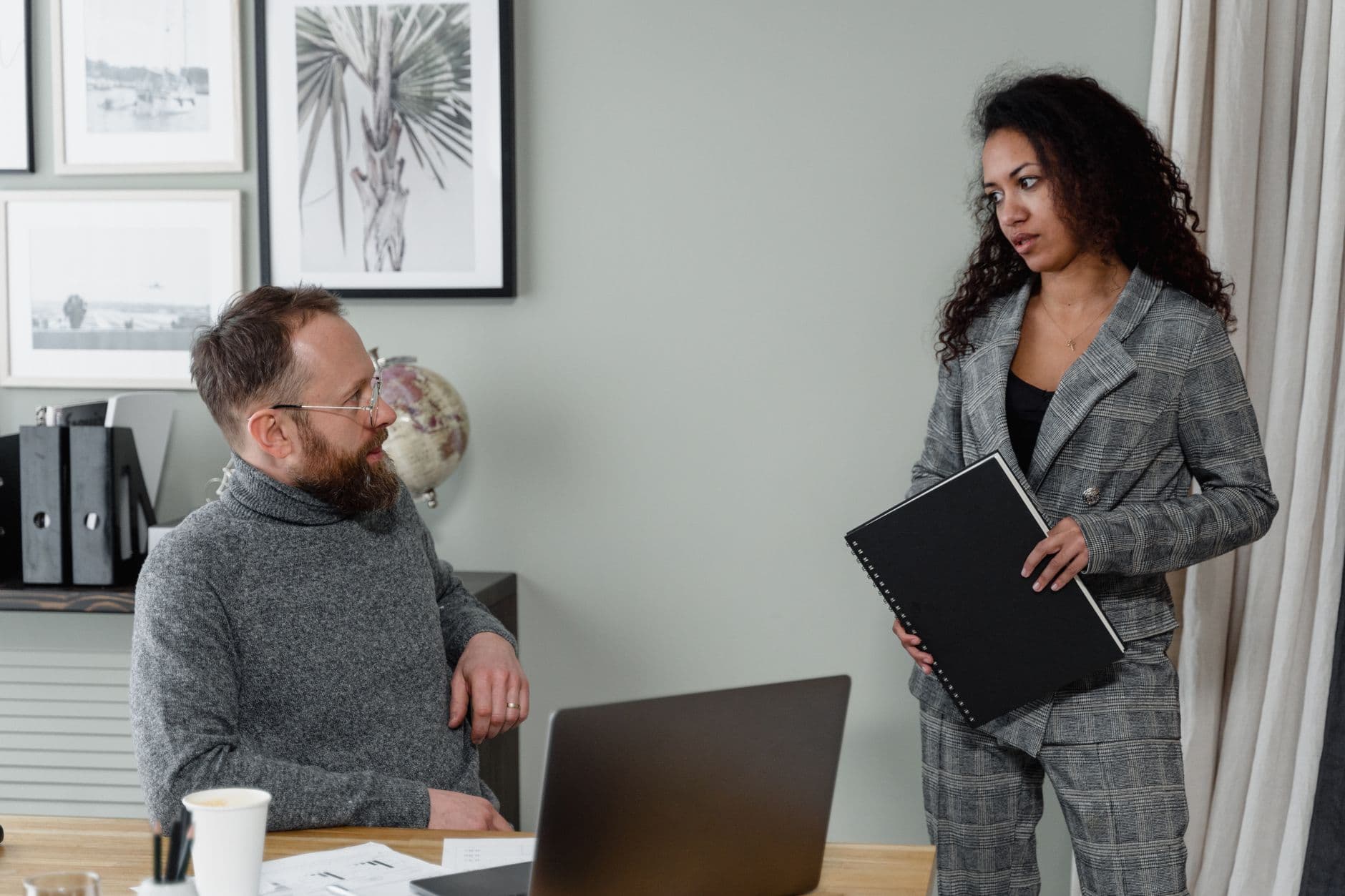 Farm owner and accountant discussing tax documents in an office