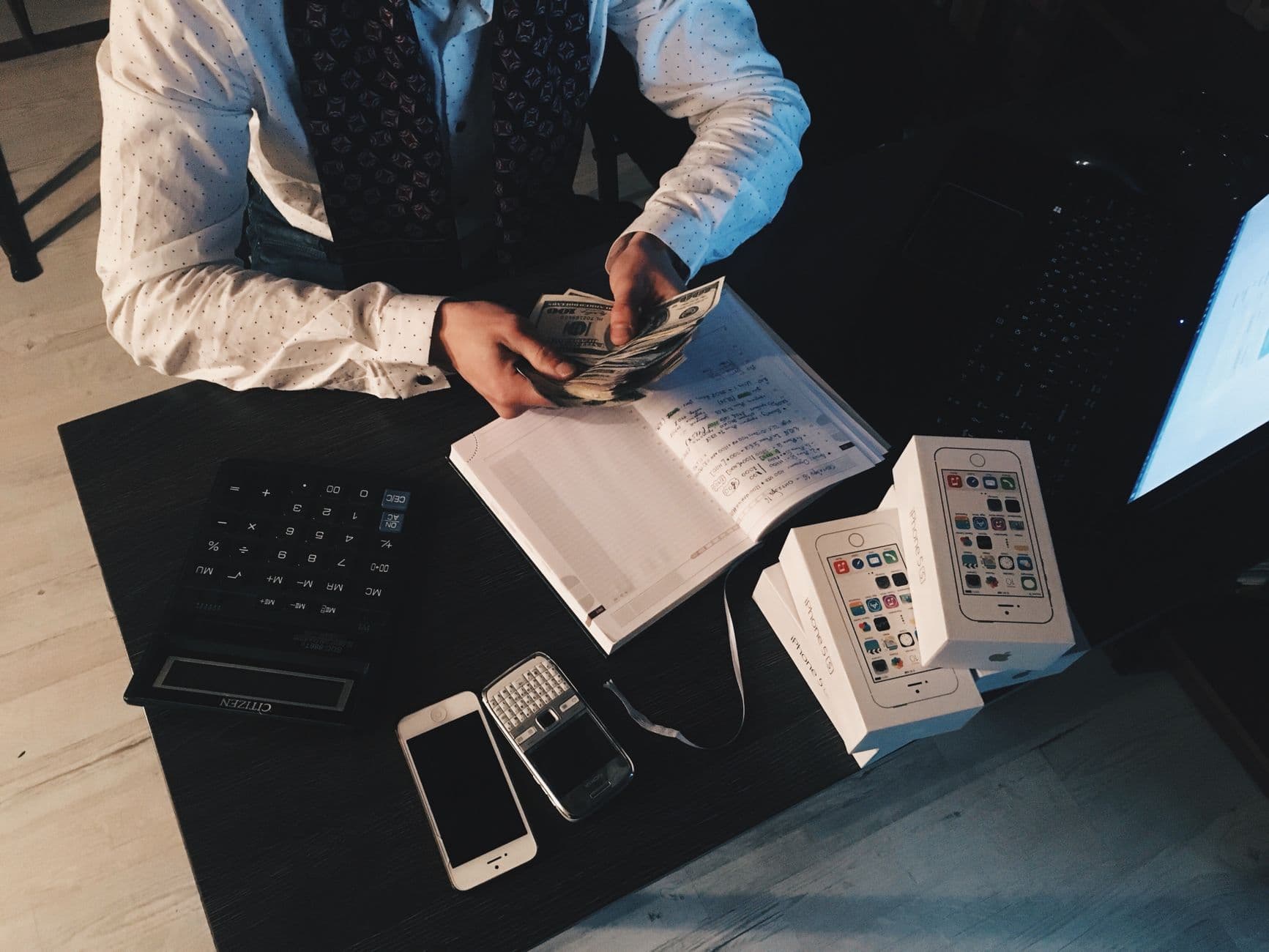 Accountant and small business owner reviewing financial documents together in an office