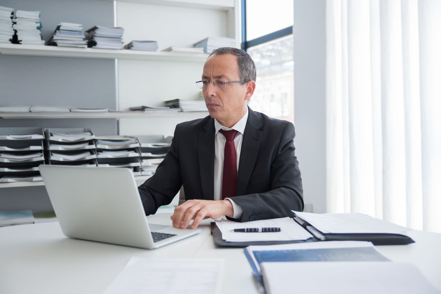 Accountant and business owner reviewing financial reports on a laptop