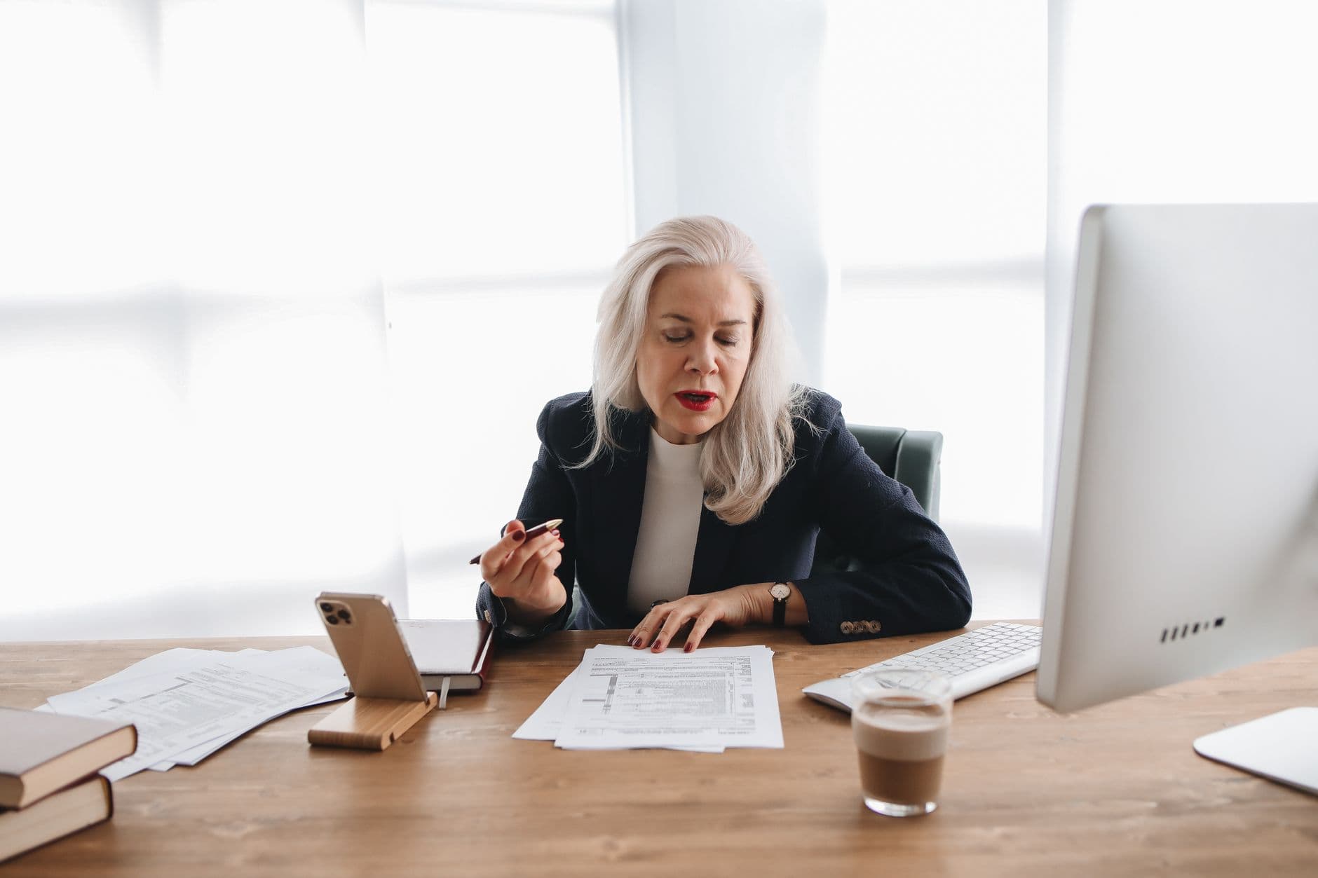 Accountant reviewing payroll tax compliance documents at a desk