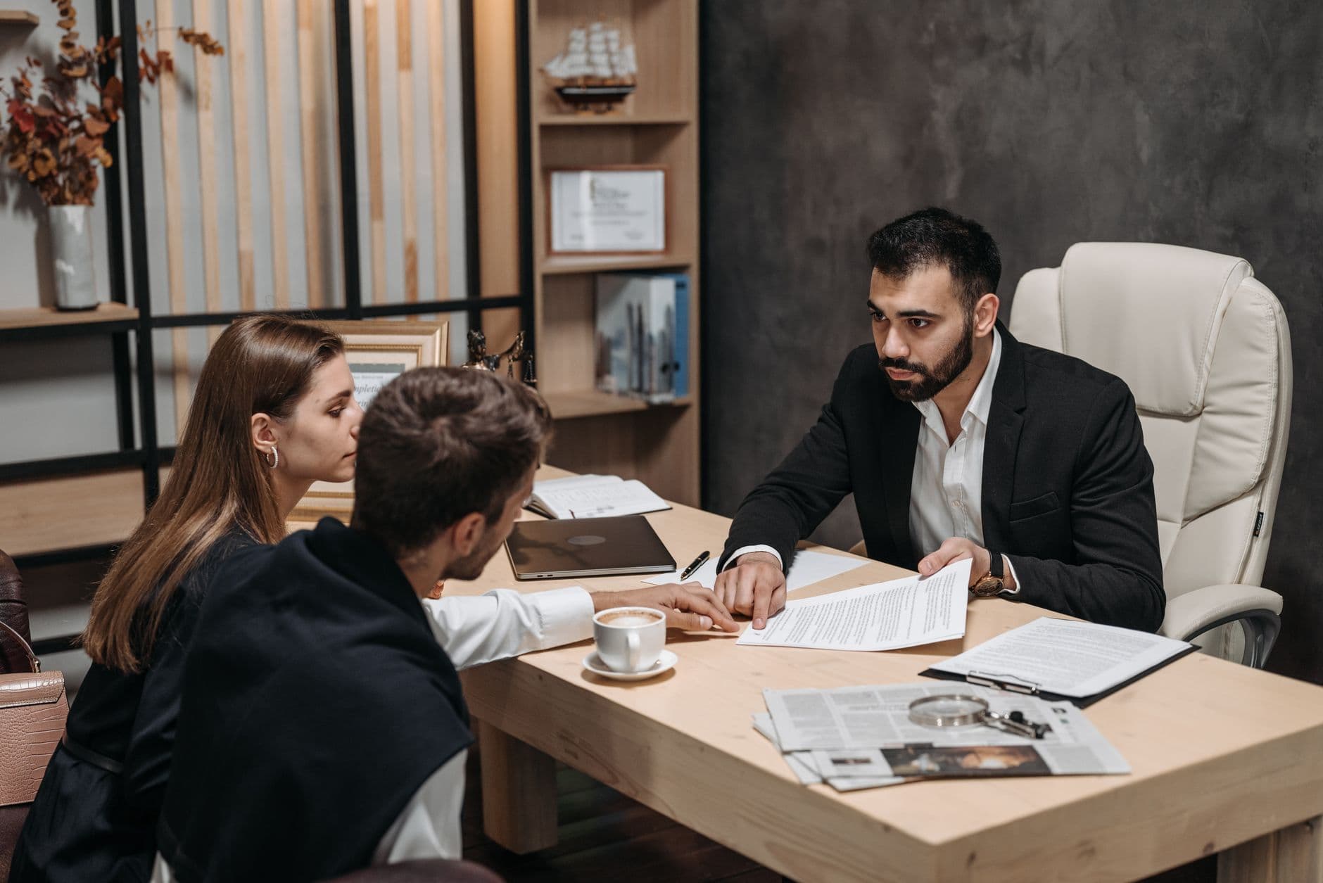 CPA reviewing personal tax documents with a business owner client at a desk