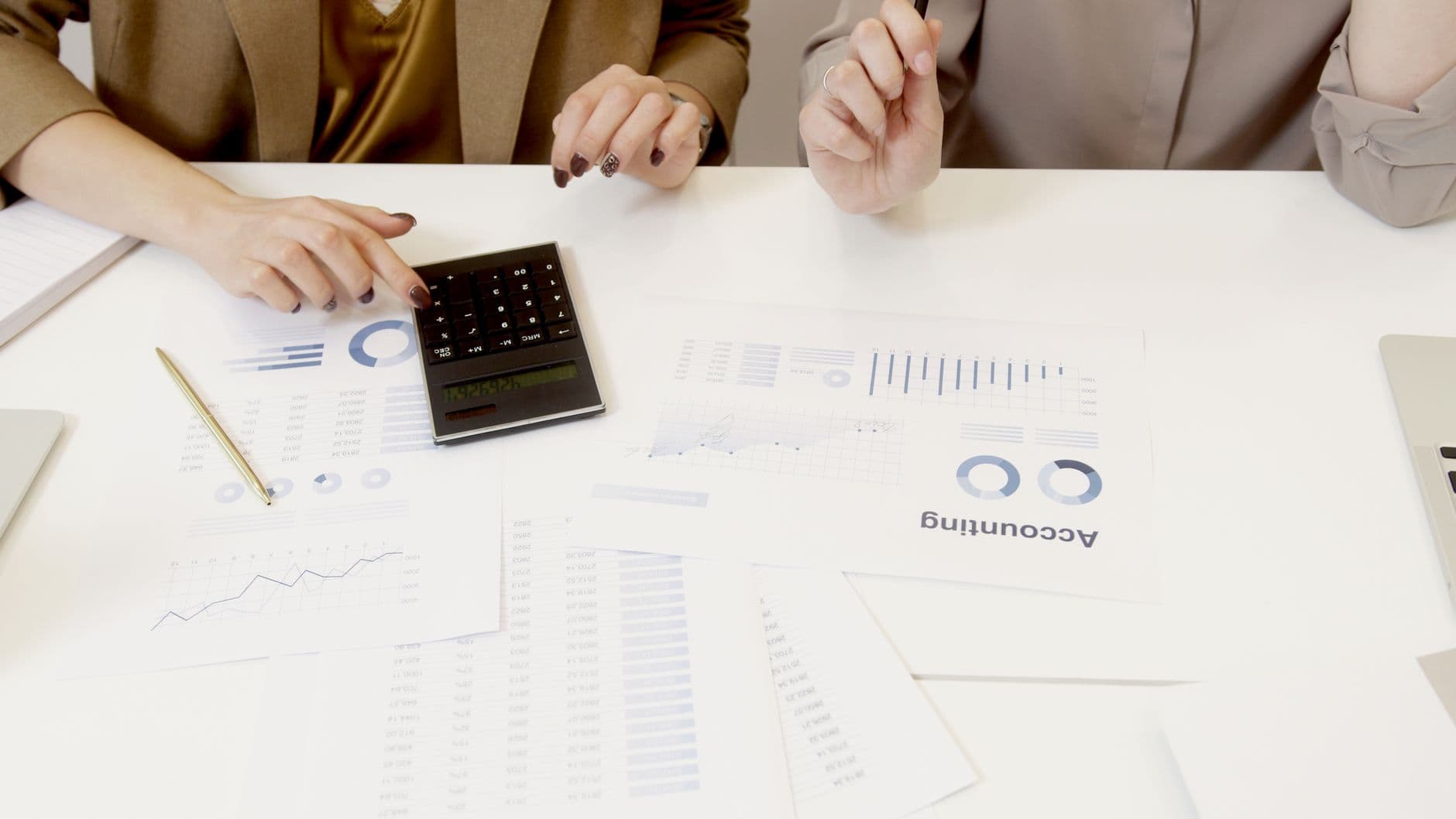 CPA and small business owner reviewing tax documents at a desk
